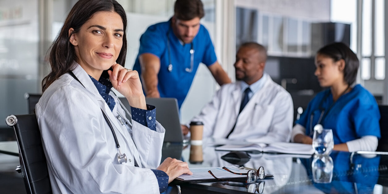 doctor smiling at meeting discussing marketing for medical and health industry