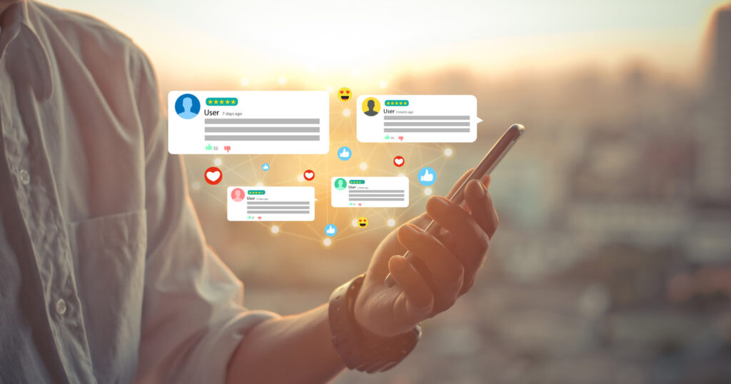 visual representation of social media feedback - boxes with ratings and reviews floating up from phone